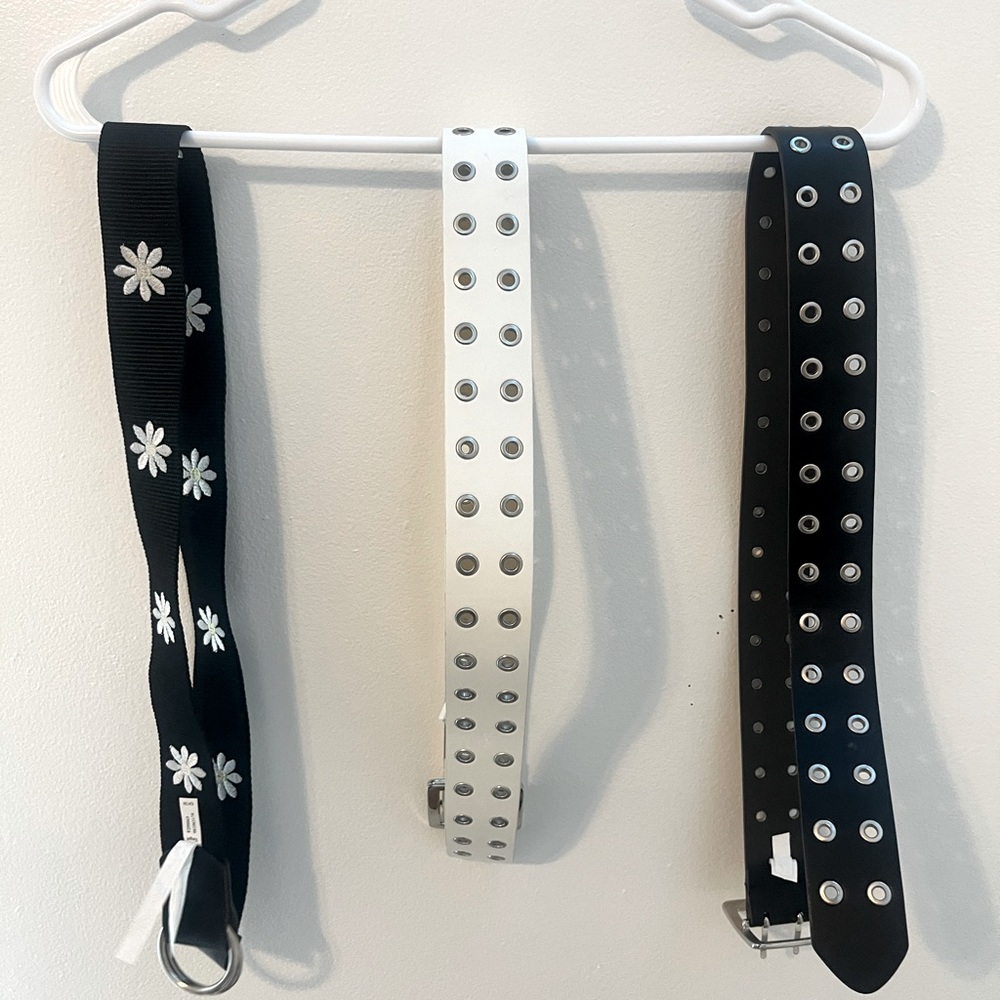 3 belts a black, white, and flower print belt